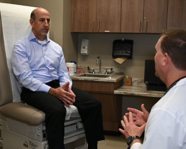 Dr Kahn Talking With A Patient