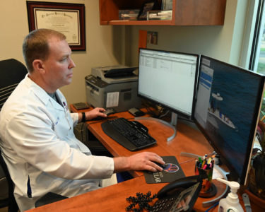 Dr Kahn Looking At Computer Monitors