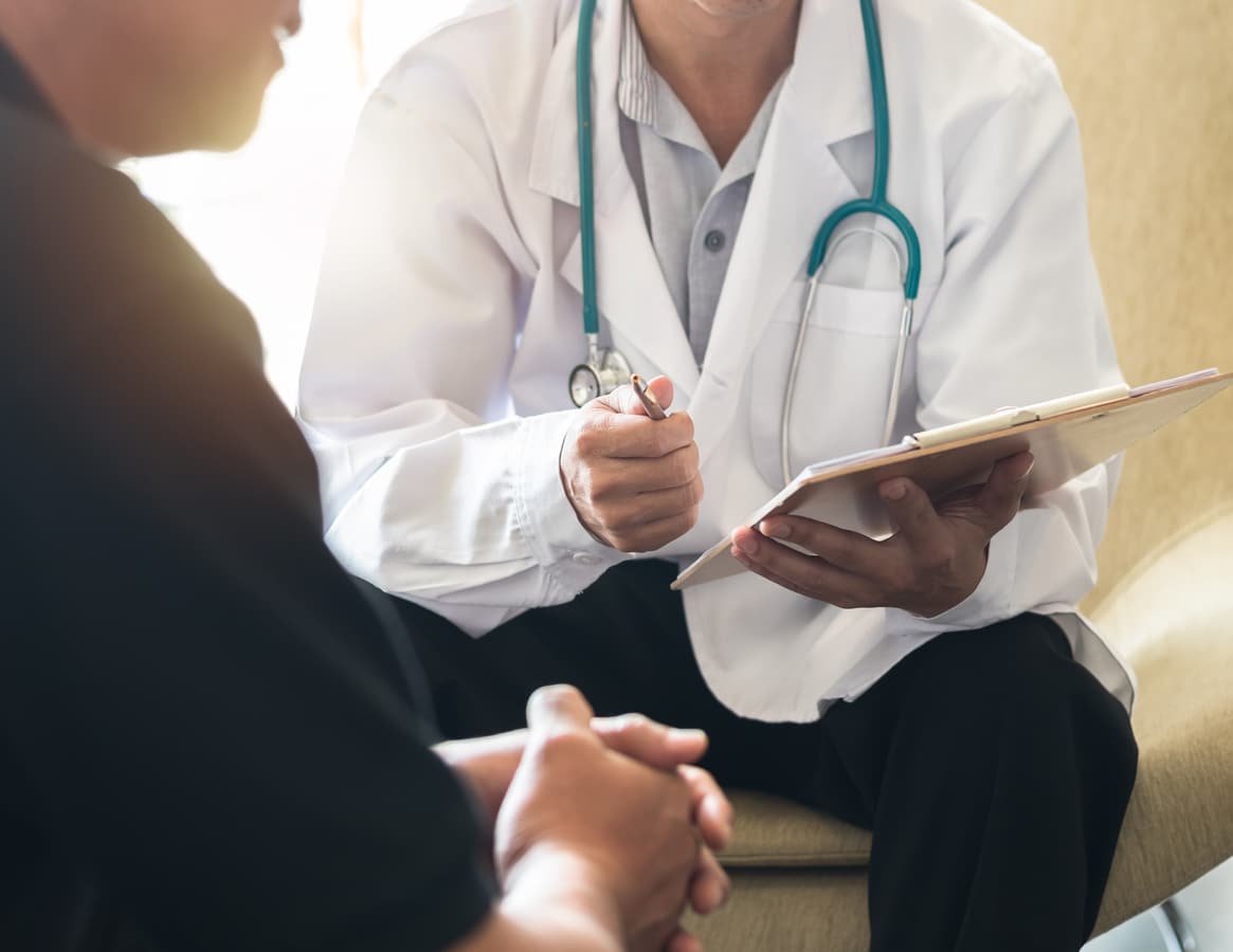Men's health exam with doctor or psychiatrist working with patient having consultation on diagnostic examination on male disease or mental illness in medical clinic or hospital mental health service Men's health exam with doctor or psychiatrist working with patient having consultation on diagnostic examination on male disease or mental illness in medical clinic or hospital mental health service